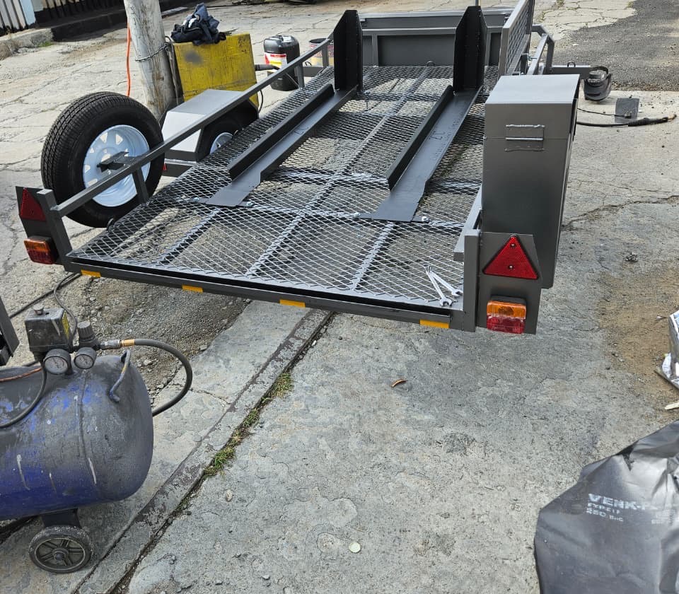 Charcoal motorbike trailer with mesh deck and toolbox